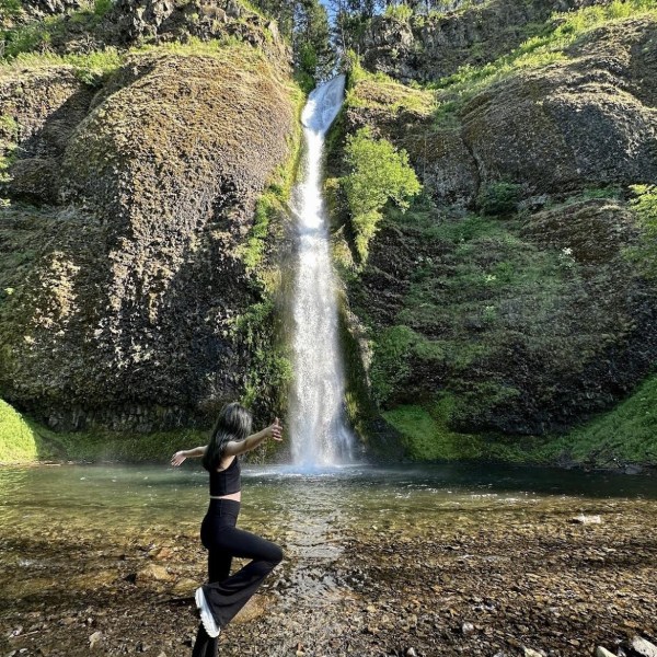 a person standing next to a waterfall