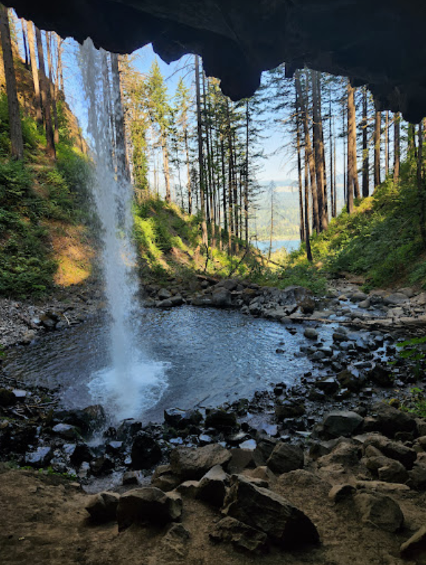 a large waterfall over some water