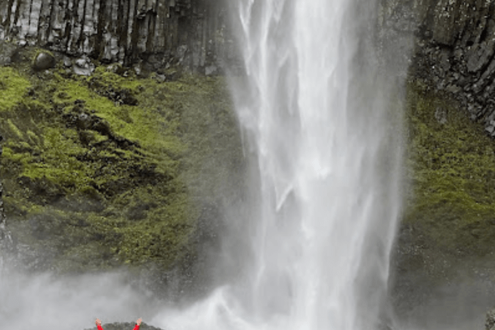 a large waterfall over some water